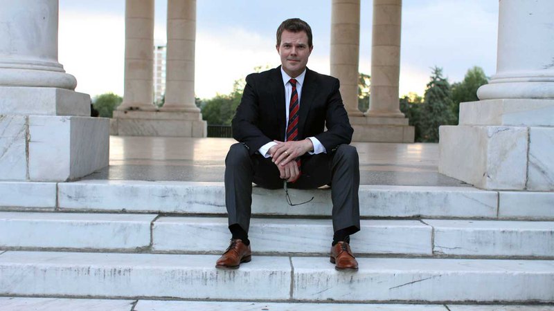 criminal defense attorney sitting on marble steps of a building